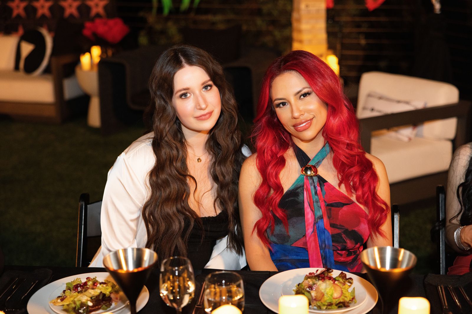 Two cast members at the candle-lit fine-dining dinner in the backyard