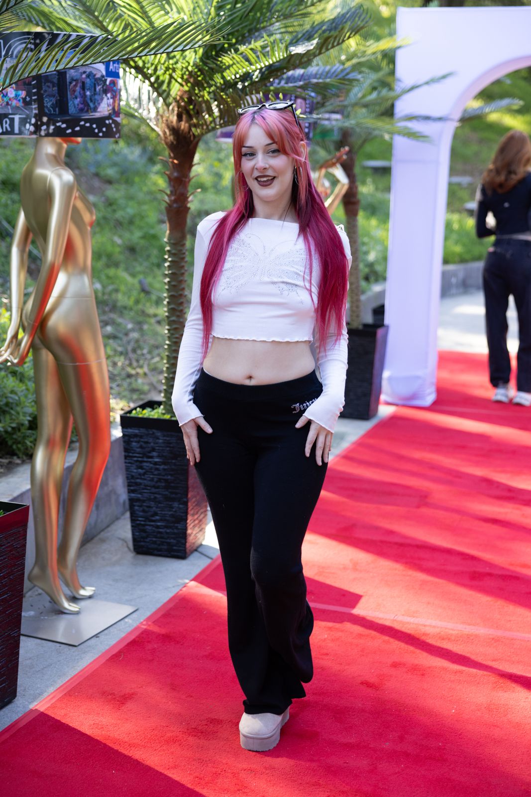 A Stripchat House Hollywood cast member arrives on the red carpet outside the Hollywood Hills mansion