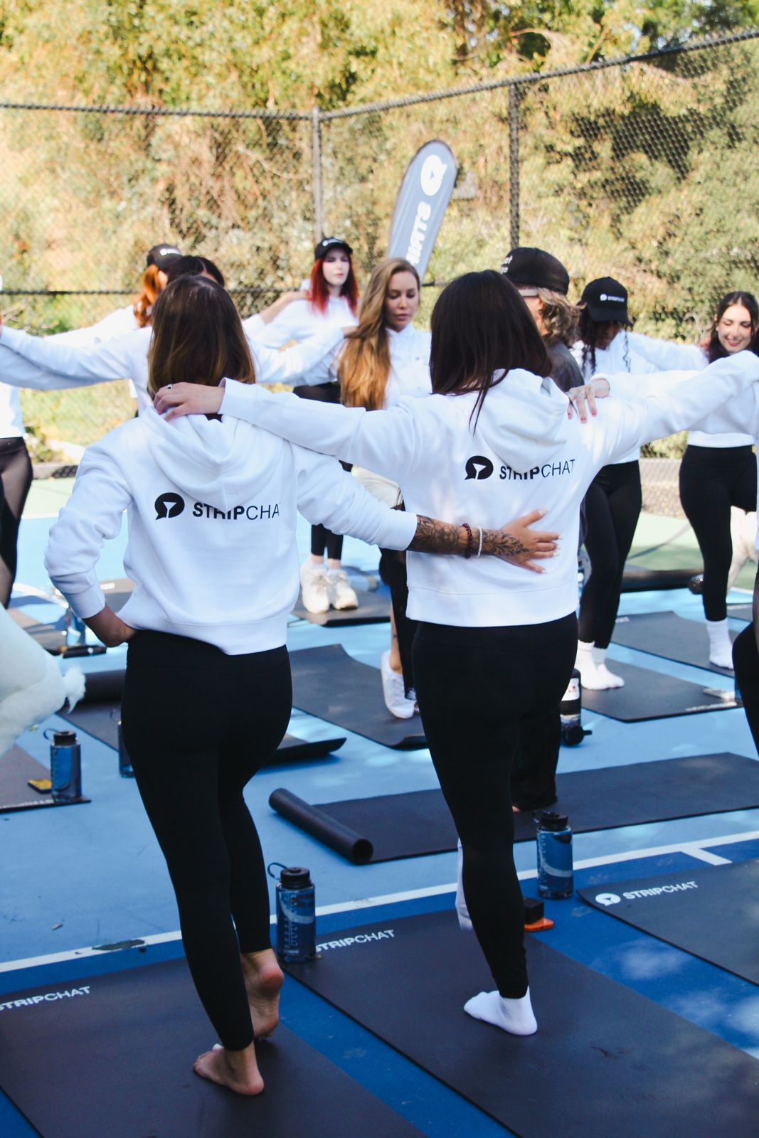 Goat yoga session on the pickleball court at the Stripchat House Hollywood, goats climbing on cast members' backs
