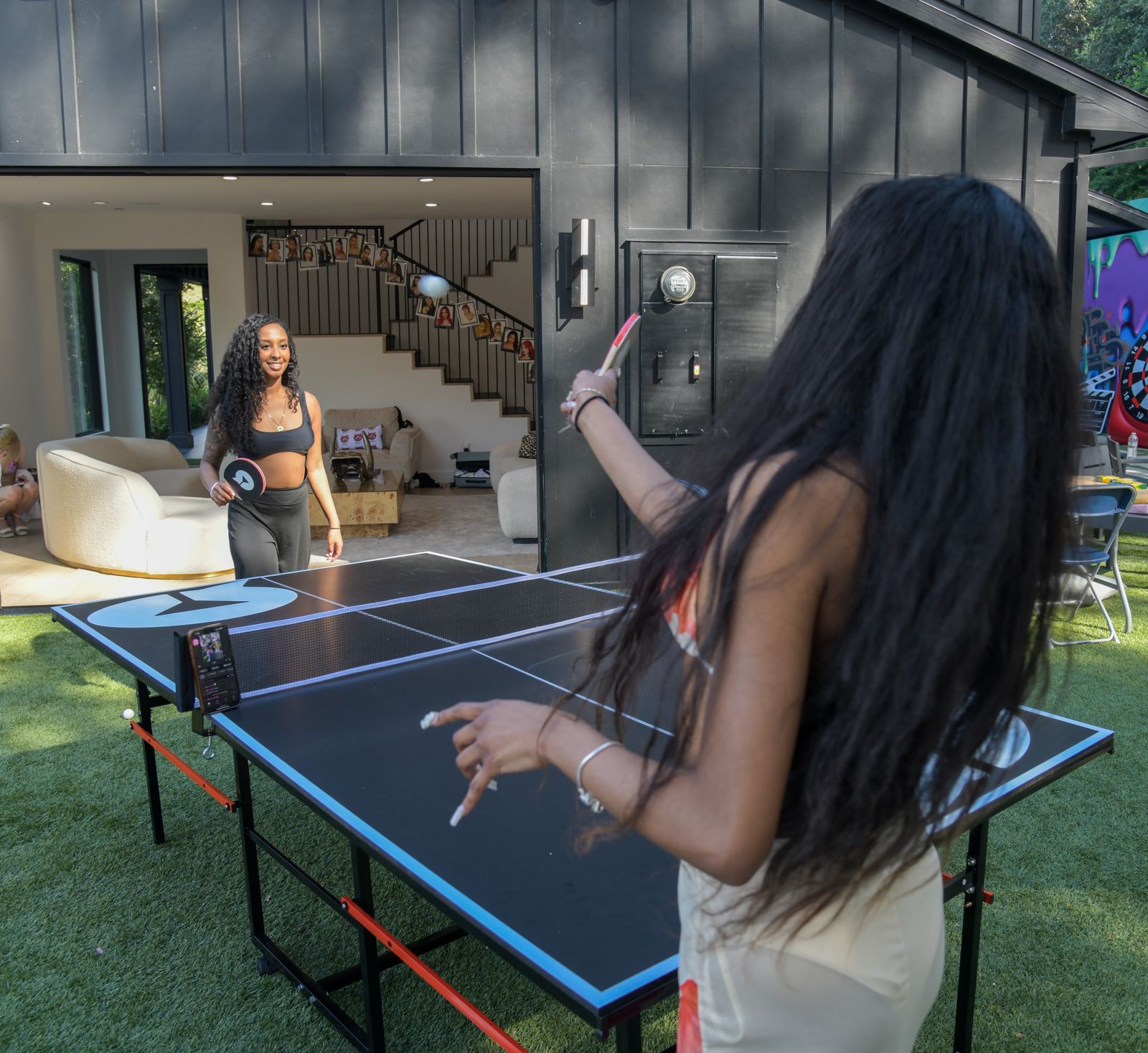 Cast members relaxing around the Stripchat House Hollywood mansion between shoots