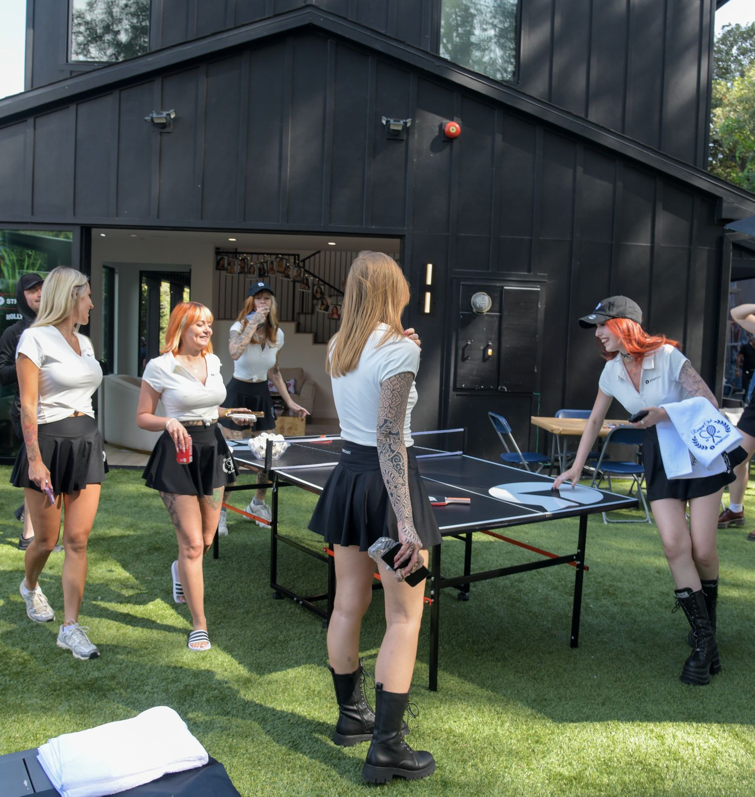 Cast members relaxing around the Stripchat House Hollywood mansion between shoots