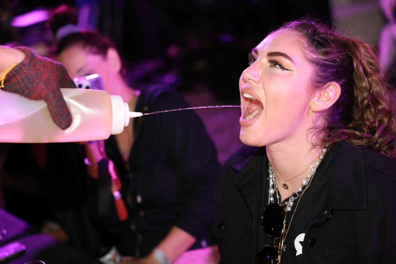 The interactive hibachi dinner at the Stripchat House, chef sake bottles and all