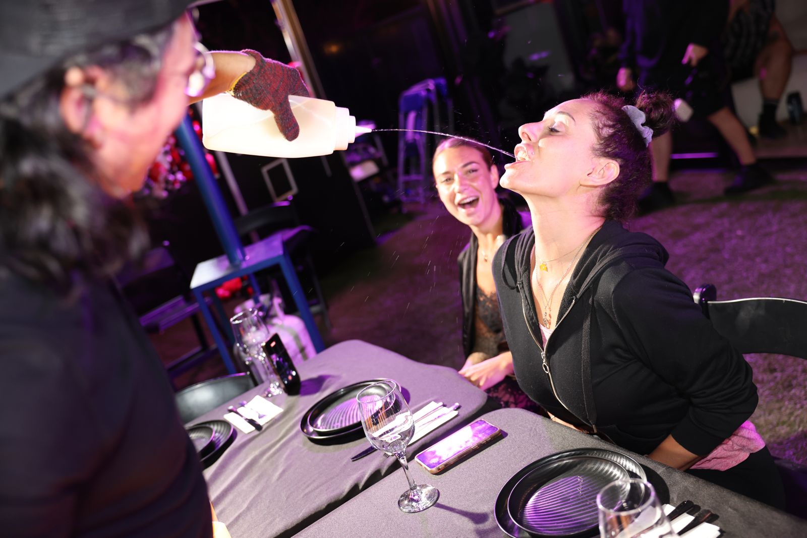 The interactive hibachi dinner at the Stripchat House, chef sake bottles and all