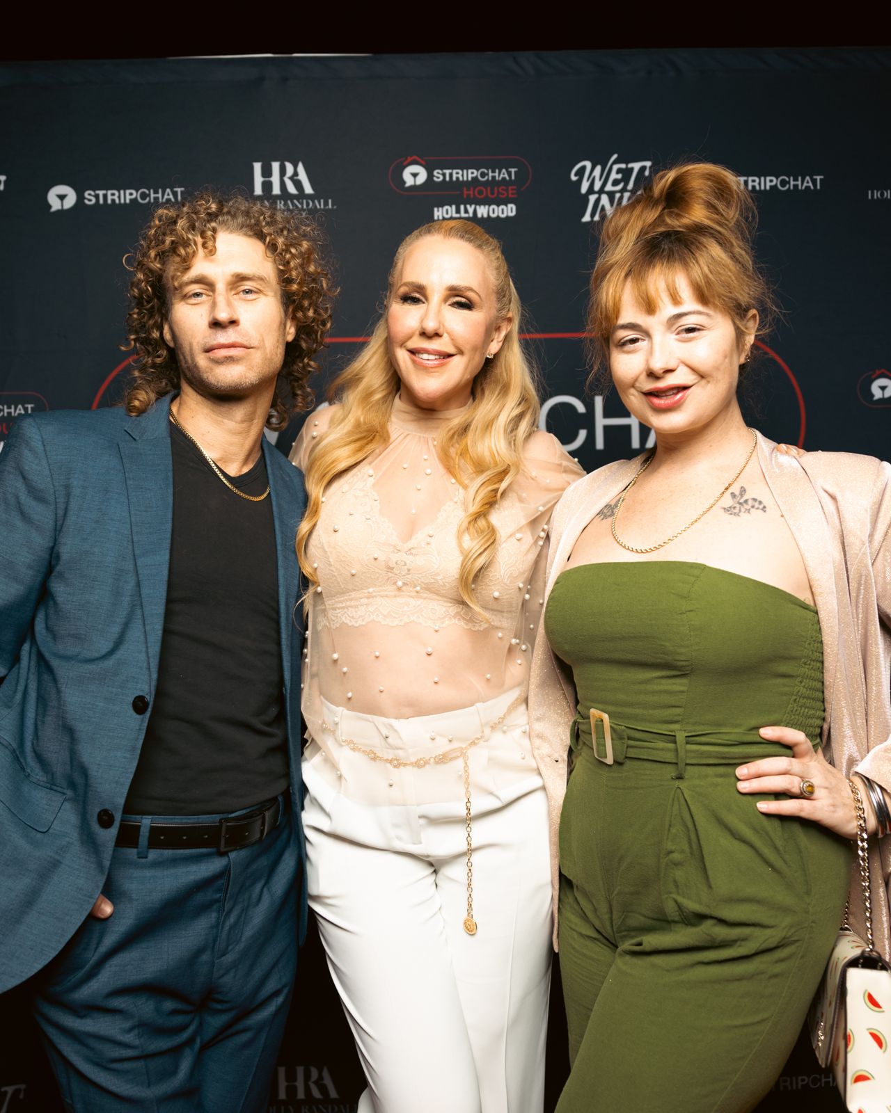Guests on the Stripchat House Hollywood and Wet Ink magazine step-and-repeat wall at the launch party