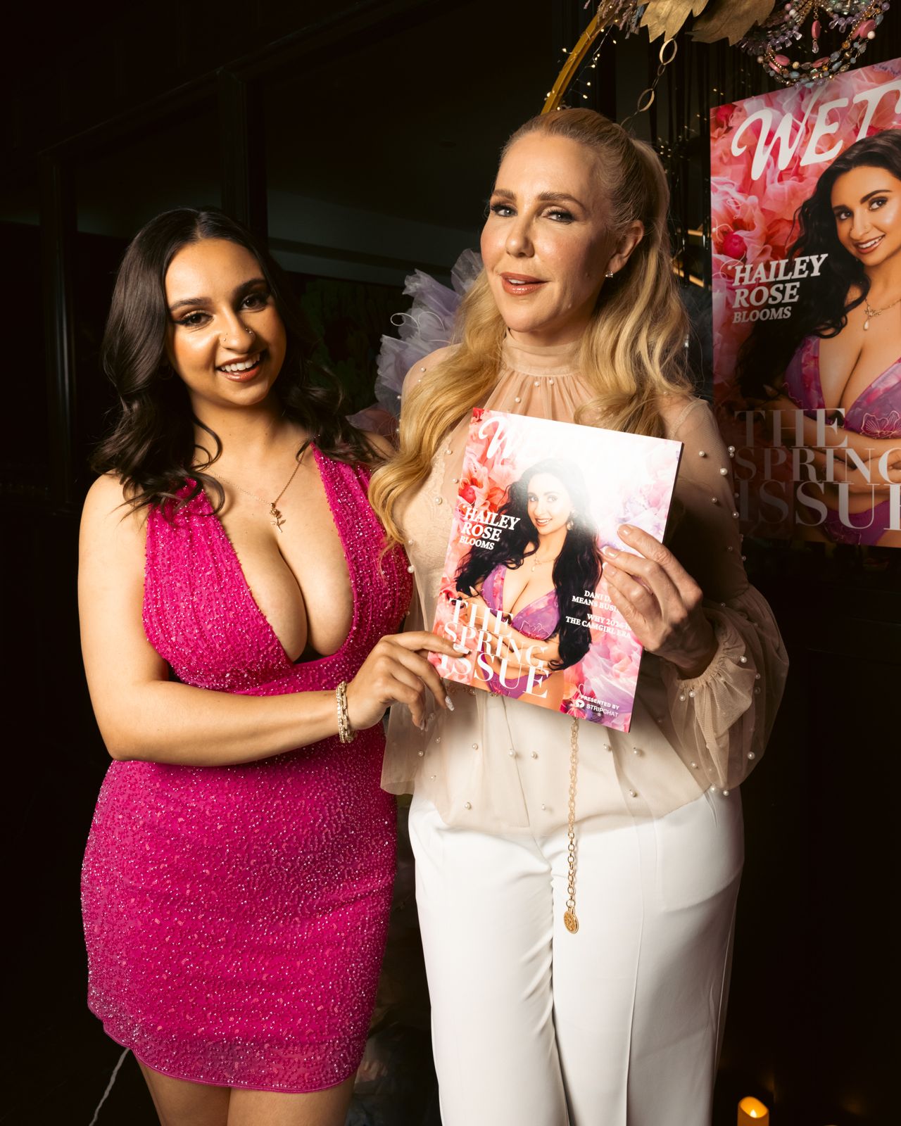 Guests hold the Hailey Rose cover of Wet Ink magazine at the Stripchat House Hollywood launch party